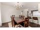 Charming dining area with a view into a bright, remodeled kitchen with white cabinets and bold wallpaper at 1209 W Colter St, Phoenix, AZ 85013