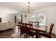 Inviting dining room with wood table and chairs, adjacent to a living area and sliding doors to the pool at 1209 W Colter St, Phoenix, AZ 85013
