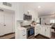 Bright kitchen featuring white cabinetry, granite countertops, stainless steel appliances, and mosaic backsplash at 1209 W Colter St, Phoenix, AZ 85013