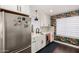 Charming kitchen with white cabinets, stainless steel appliances, and a unique botanical wallpaper accent wall at 1209 W Colter St, Phoenix, AZ 85013