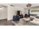Bright living room with modern decor, hardwood floors, and a large window overlooking the pool at 1209 W Colter St, Phoenix, AZ 85013