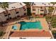 Overhead shot of the community pool, showing lounge seating and proximity to residential buildings at 12123 W Bell Rd # 211, Surprise, AZ 85378
