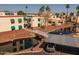 A multi-level condo community features a waterway, mature landscaping, and covered parking at 12123 W Bell Rd # 211, Surprise, AZ 85378