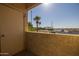 Tranquil balcony view featuring palm trees, utility wires, and street, bringing the outdoors in at 12123 W Bell Rd # 211, Surprise, AZ 85378