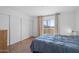 Bright bedroom boasts a sliding glass door to balcony, neutral decor, and closet at 12123 W Bell Rd # 211, Surprise, AZ 85378