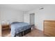 Comfortable bedroom with simple decor, closet, and wooden nightstand, offering a serene retreat at 12123 W Bell Rd # 211, Surprise, AZ 85378
