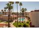 Relaxing community pool surrounded by palm trees and lush landscaping at 12123 W Bell Rd # 211, Surprise, AZ 85378