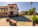 Building exterior showing the shuffleboard court and well-maintained landscaping with mature trees at 12123 W Bell Rd # 211, Surprise, AZ 85378
