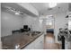 Modern kitchen with granite countertops, stainless steel appliances, and view to the bedroom at 12123 W Bell Rd # 211, Surprise, AZ 85378
