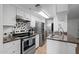 Well-lit kitchen with stainless steel appliances, granite countertops, and open access to the living room at 12123 W Bell Rd # 211, Surprise, AZ 85378