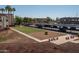 Exterior shot of parking lot and adjacent recreational area with mature trees at 12123 W Bell Rd # 211, Surprise, AZ 85378