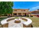 Expansive backyard featuring a fire pit with built-in seating and a spacious lawn at 13324 W Annika Dr, Litchfield Park, AZ 85340