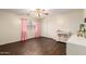 Bedroom featuring a ceiling fan, wood-look floors, and pink accents at 13324 W Annika Dr, Litchfield Park, AZ 85340