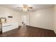 Bedroom features a ceiling fan, wood-look floors, and open doorway to ensuite bathroom at 13324 W Annika Dr, Litchfield Park, AZ 85340