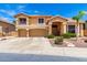 Inviting two-story home showcasing a well-manicured lawn and a spacious three-car garage at 13324 W Annika Dr, Litchfield Park, AZ 85340