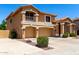Lovely two-story home with a three-car garage, desert landscaping, and an inviting front entrance at 13324 W Annika Dr, Litchfield Park, AZ 85340