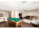 Open game room with a pool table, cozy seating, and ample space for entertainment at 13324 W Annika Dr, Litchfield Park, AZ 85340