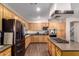 Modern kitchen featuring stainless steel appliances, granite countertops, and wooden cabinetry at 13324 W Annika Dr, Litchfield Park, AZ 85340
