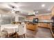 Bright kitchen with wooden cabinets, an island cooktop, stainless steel appliances, and an adjacent dining area at 13324 W Annika Dr, Litchfield Park, AZ 85340