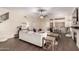 Bright and open living space with hardwood floors, comfortable seating, and a stylish wet bar at 13324 W Annika Dr, Litchfield Park, AZ 85340
