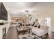 Inviting living room with plush seating, a modern fireplace, and open access to the kitchen at 13324 W Annika Dr, Litchfield Park, AZ 85340
