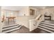 Staircase leading to the game room and other living spaces with dark wood floors at 13324 W Annika Dr, Litchfield Park, AZ 85340