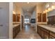 Spacious main bathroom with dual vanities, wood cabinets, and an arched hallway leading to the main bedroom at 14332 E Bobwhite Way, Scottsdale, AZ 85262
