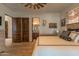 Bright bedroom featuring stylish decor, wood flooring and an open doorway to the bathroom at 14332 E Bobwhite Way, Scottsdale, AZ 85262