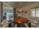 Dining room featuring a unique wooden table with white chairs and pendant lights at 14332 E Bobwhite Way, Scottsdale, AZ 85262