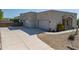 Wide angle daytime view of stucco home featuring an expansive driveway and three car garage at 14332 E Bobwhite Way, Scottsdale, AZ 85262