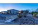 Desert home featuring a white bridge with desert landscaping at twilight at 14332 E Bobwhite Way, Scottsdale, AZ 85262