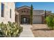 Beautiful front entrance features stone accents and desert landscaping at 14332 E Bobwhite Way, Scottsdale, AZ 85262