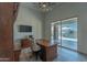 Bright home office with desk, cabinet, TV, and sliding glass doors with views of the outdoor pool area at 14332 E Bobwhite Way, Scottsdale, AZ 85262
