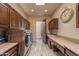 Spacious laundry room features custom wood cabinets, countertop space and modern washer and dryer at 14332 E Bobwhite Way, Scottsdale, AZ 85262