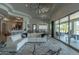 Open-concept living room with stylish white sectional, modern rug, and sliding glass doors to outdoor patio at 14332 E Bobwhite Way, Scottsdale, AZ 85262