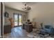 Well-lit home office with a large desk, comfortable seating, and views of the desert landscape through French doors at 14332 E Bobwhite Way, Scottsdale, AZ 85262