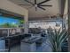 Cozy covered patio featuring comfortable seating, a fire pit, and outdoor ceiling fans at 14332 E Bobwhite Way, Scottsdale, AZ 85262
