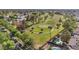 Aerial view showcases the golf course, the adjacent pool, and lush landscaping from above at 1509 W Kiowa Ave, Mesa, AZ 85202