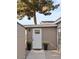The side entrance of the house features a white door, pot plants, and rock landscaping at 1509 W Kiowa Ave, Mesa, AZ 85202