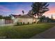 Well-maintained home with mature landscaping, a front lawn, and a private gate at 1509 W Kiowa Ave, Mesa, AZ 85202