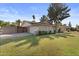 Landscaped front yard, gated driveway, and a two-car garage enhance the home's curb appeal at 1509 W Kiowa Ave, Mesa, AZ 85202