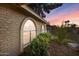 Arched windows with lush landscaping offer unique charm to this home at 1509 W Kiowa Ave, Mesa, AZ 85202