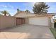 Exterior showcasing a two-car garage and a private, gated driveway at 1509 W Kiowa Ave, Mesa, AZ 85202
