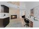 Home office with stone fireplace, black accent chair, modern desk, and black cabinetry at 1509 W Kiowa Ave, Mesa, AZ 85202
