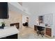 Bright home office with a stone fireplace, modern desk, and artwork at 1509 W Kiowa Ave, Mesa, AZ 85202