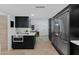 Well-lit kitchen featuring black cabinets, stainless steel refrigerator, white countertops and adjacent office space at 1509 W Kiowa Ave, Mesa, AZ 85202