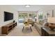 Cozy living room with ample seating and sliding glass doors leading to the backyard and pool at 1509 W Kiowa Ave, Mesa, AZ 85202