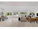 Open living room with dining area, white sofas, and views of the backyard pool area at 1509 W Kiowa Ave, Mesa, AZ 85202
