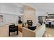 Bright, open-concept living area with fireplace, modern lighting, and wet bar at 1509 W Kiowa Ave, Mesa, AZ 85202
