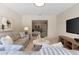 Spacious living room with comfortable seating, TV, and a seamless transition to the serene bedroom at 1509 W Kiowa Ave, Mesa, AZ 85202